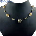 Load image into Gallery viewer, A beaded necklace with yellow and green stones strung on a black cord, on a black jewelry stand.