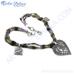 Load image into Gallery viewer, Silver beaded necklace with heart-shaped pendant, featuring gemstones and intricate details.