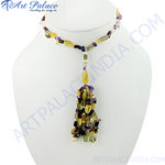 Load image into Gallery viewer, Colorful beaded gemstone tassel necklace on a white mannequin. Featuring a variety of stones and textures.
