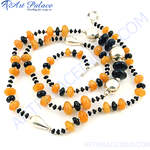 Load image into Gallery viewer, Sterling silver necklace featuring orange and black gemstones strung together.