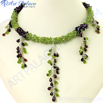 Load image into Gallery viewer, Green peridot and garnet beaded necklace with sterling silver accents. Features teardrop gemstone dangles.