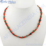 Load image into Gallery viewer, A necklace featuring gray labradorite and orange carnelian beads on a white background.