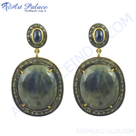 Load image into Gallery viewer, Sapphire and diamond drop earrings, featuring a large oval sapphire and smaller sapphire stud, set in a gold-plated frame.