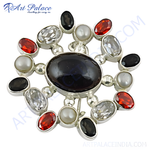 Load image into Gallery viewer, Sterling silver brooch with oval black gemstone center and surrounding red, white and black stones, and pearls.