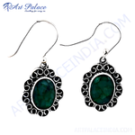 Load image into Gallery viewer, Sterling silver dangle earrings with oval emerald gemstones. Green stone in a detailed silver setting.