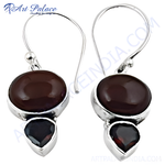 Load image into Gallery viewer, 925 sterling silver drop earrings with oval and pear-shaped garnet gemstones in a bezel setting.