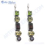 Load image into Gallery viewer, Sterling silver drop earrings featuring green peridot and dark red garnet gemstones in a dangling design.