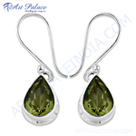 Load image into Gallery viewer, 925 sterling silver dangle earrings featuring teardrop-shaped peridot gemstones in a bezel setting.