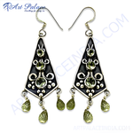 Load image into Gallery viewer, 925 sterling silver dangle earrings featuring peridot gemstones in a teardrop shape. Green gemstone earrings with silver accents.