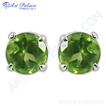 Load image into Gallery viewer, Silver stud earrings with round-cut, vibrant green peridot gemstones.