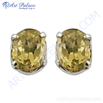 Load image into Gallery viewer, Sterling silver stud earrings with oval-cut yellow citrine gemstones. Elegant and sparkling design.