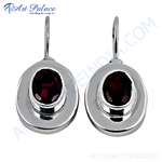 Load image into Gallery viewer, 925 sterling silver drop earrings with oval-cut red garnet gemstones.