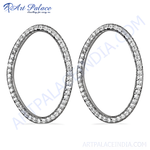 Load image into Gallery viewer, Silver oval hoop earrings with sparkling diamonds on a white background, showcasing elegant women's jewelry.