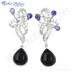 Load image into Gallery viewer, Sterling silver dangle earrings with black teardrop onyx gemstones and purple accents on white background.