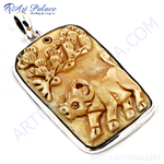 Load image into Gallery viewer, Sterling silver carved ox pendant with detailed animal carving on a beige background.