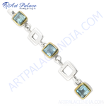 Load image into Gallery viewer, Sterling silver chain bracelet with blue topaz gemstones and gold plating accents, elegant design.