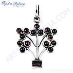 Load image into Gallery viewer, Sterling silver pendant necklace with a tree design featuring round garnet gemstones.
