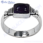 Load image into Gallery viewer, A sterling silver ring with a rectangular amethyst gemstone center in a close-up shot.