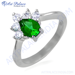 Load image into Gallery viewer, Sterling silver ring with a pear-cut green emerald gemstone and white gemstone accents.