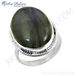 Load image into Gallery viewer, Sterling silver oval ring with a large iridescent labradorite gemstone.