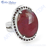 Load image into Gallery viewer, Sterling silver ring with a large oval-cut red ruby gemstone and smaller gemstones around the perimeter.