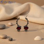 Load image into Gallery viewer, 925 sterling silver drop earrings with oval-cut red garnet gemstones.