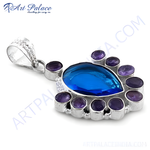 Load image into Gallery viewer, 925 sterling silver pendant with a pear-shaped blue topaz center stone and amethyst accents, displayed on a white background.
