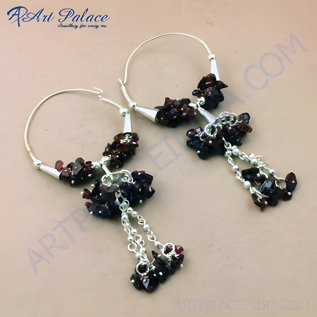 Sterling silver drop earrings featuring clusters of deep red and purple gemstones. Dangle style earrings with a hoop design.