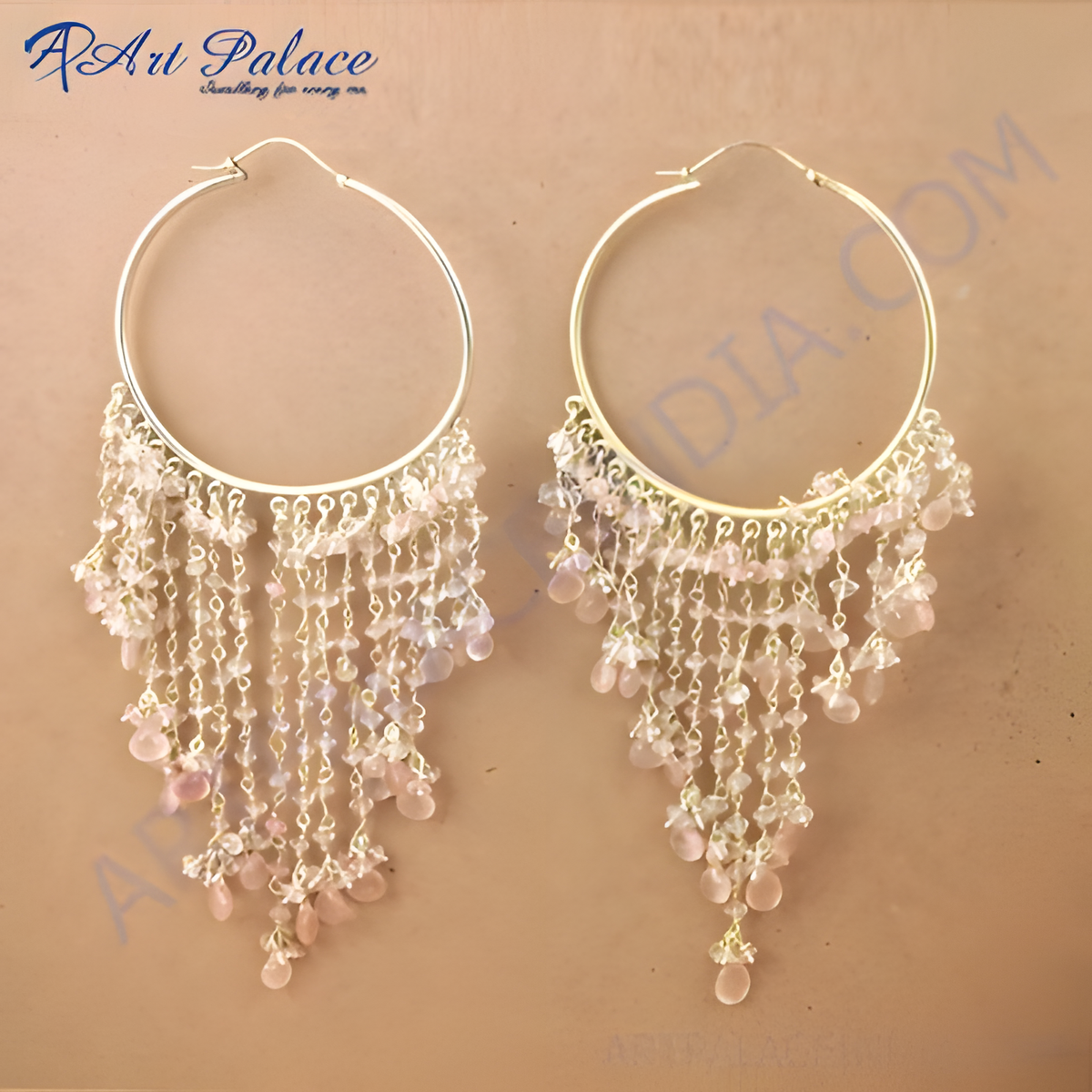 Gold hoop earrings with cascading strands of light pink gemstones, creating a beautiful dangle effect