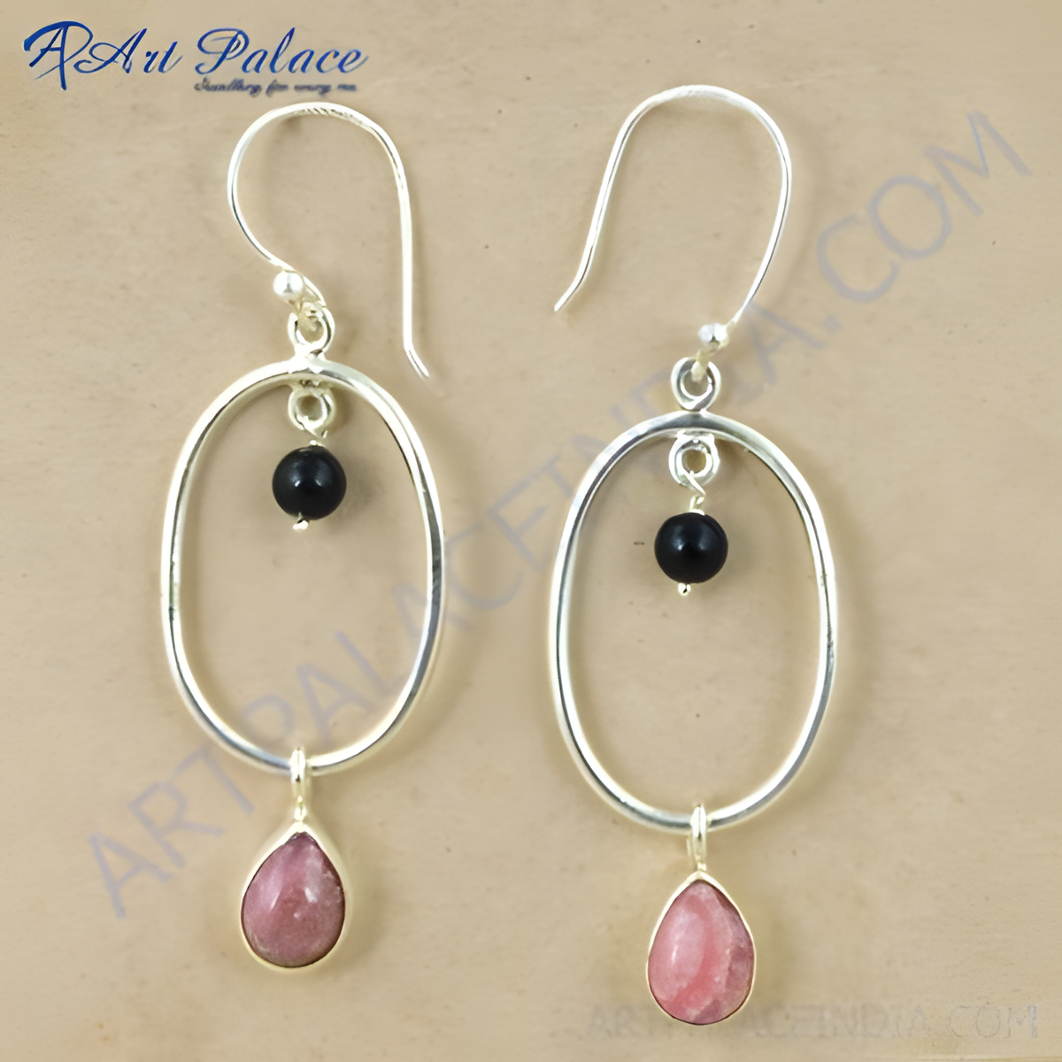 Sterling silver drop earrings featuring a pink gemstone teardrop and black bead accents