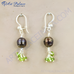Load image into Gallery viewer, Silver drop earrings featuring dark pearls and green peridot gemstones.
