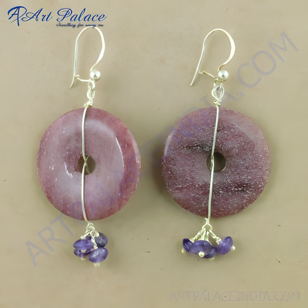 Sterling silver dangle earrings featuring a donut-shaped pink stone and small amethyst beads.