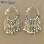 Load image into Gallery viewer, 925 sterling silver dangle earrings featuring pink rose quartz beads and silver accents.
