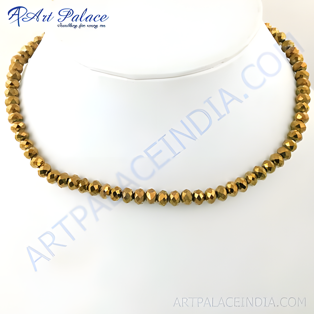 Gold beaded necklace displayed on a mannequin, faceted beads, gold color jewelry