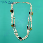 Load image into Gallery viewer, Multi-strand pearl necklace with black onyx, yellow, and gray gemstones on a teal background.
