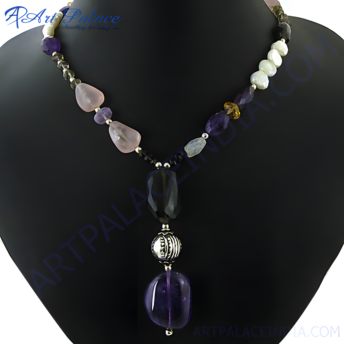 A stunning gemstone beaded necklace featuring purple, pink, and clear stones on a black display