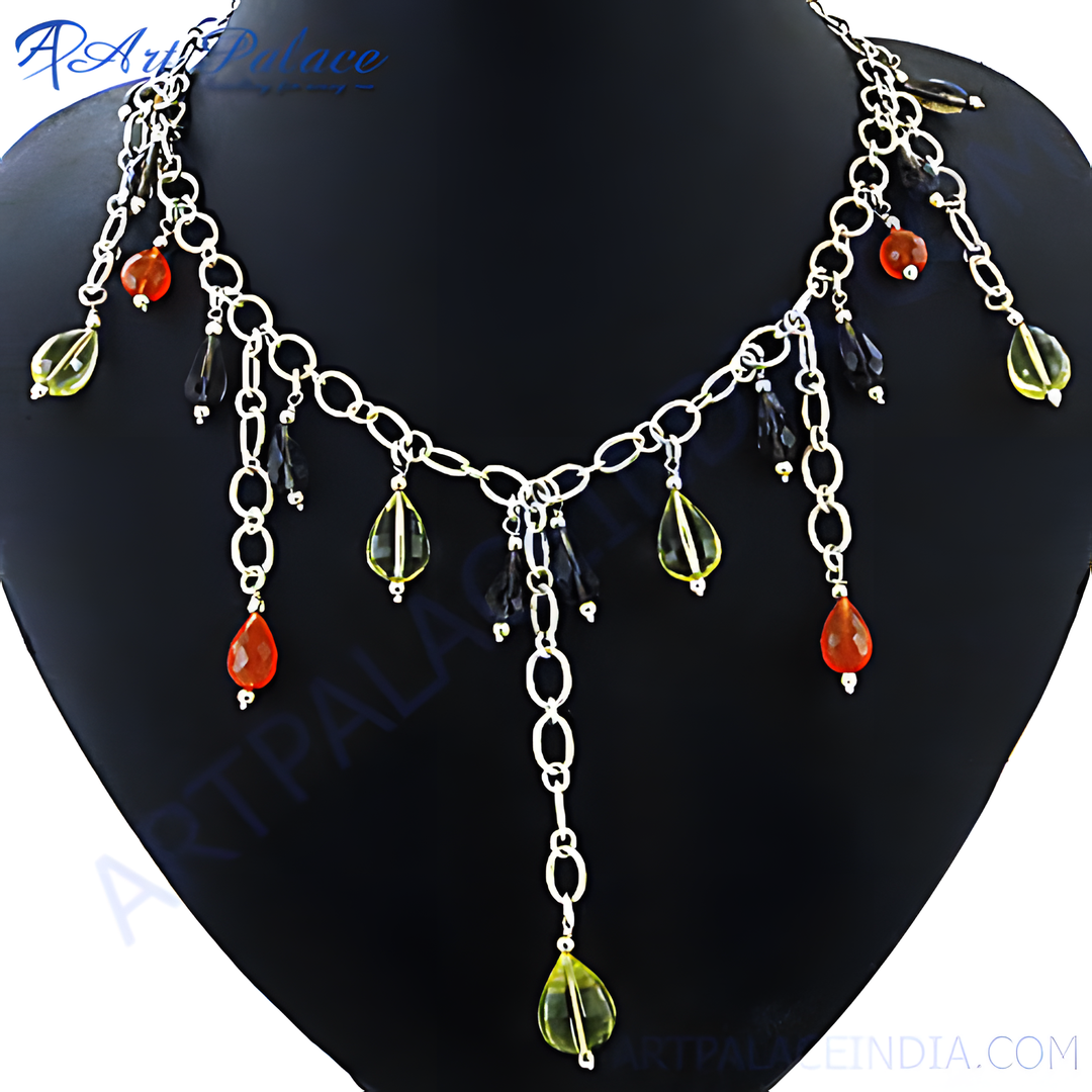 Silver chain necklace with teardrop-shaped orange and yellow gemstone accents displayed on a black bust