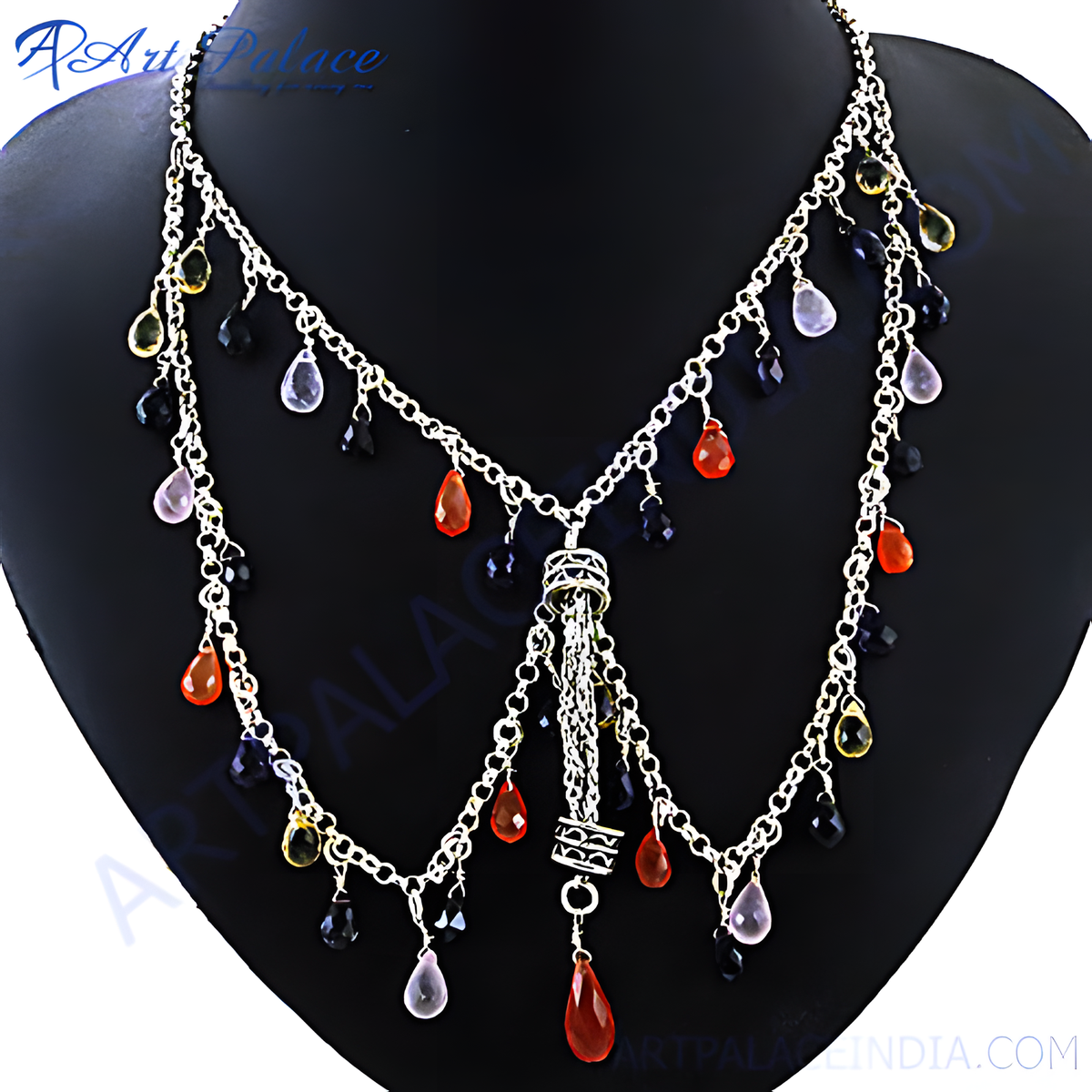 Silver cascade necklace with colorful gemstones displayed on a black mannequin