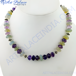 Load image into Gallery viewer, A beaded necklace featuring purple and green gemstones strung together on a necklace.
