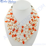 Load image into Gallery viewer, Multi-strand pearl and coral statement necklace on a white display. Features natural pearls and coral accents.
