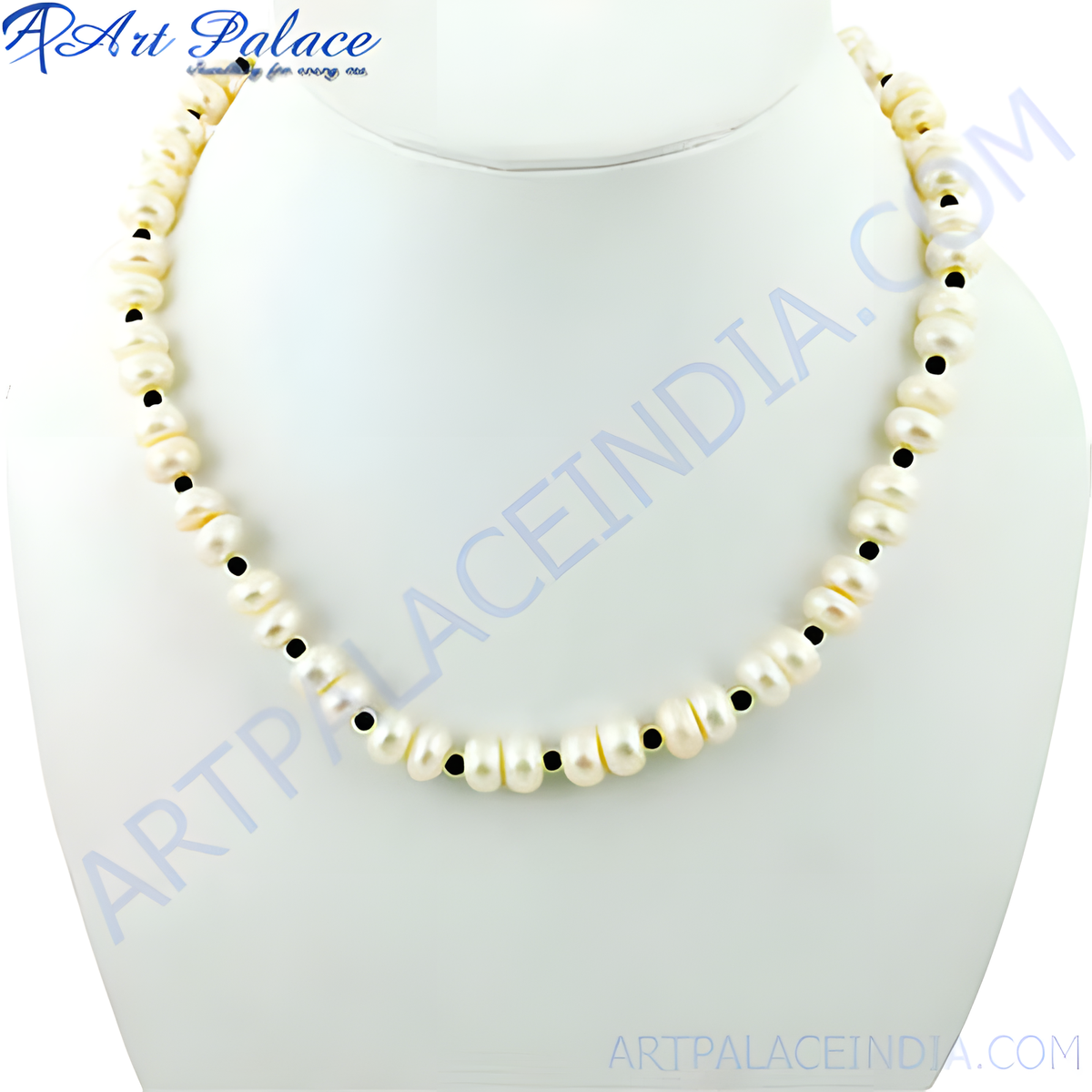 Elegant freshwater pearl necklace with black onyx bead accents on a white display