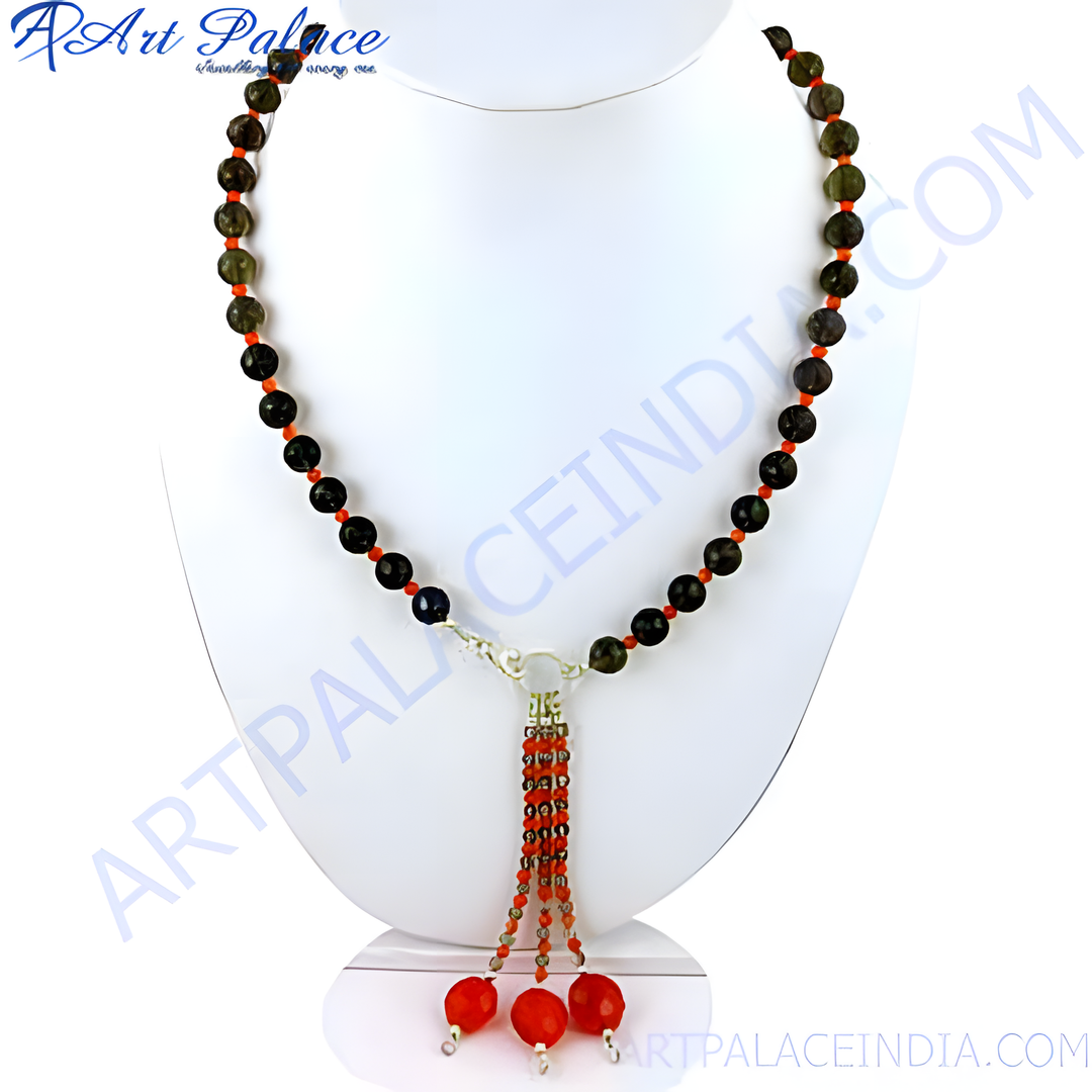 A stunning beaded gemstone necklace with dark round beads and red accents, displayed on a jewelry stand.