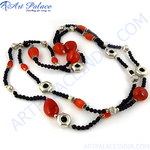 Load image into Gallery viewer, Red coral beaded necklace with black beads and silver accents on a white background, showcasing the jewelry&#39;s design
