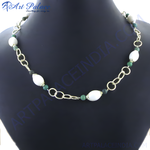 Load image into Gallery viewer, Gold chain necklace with white and green stones displayed on a black background.
