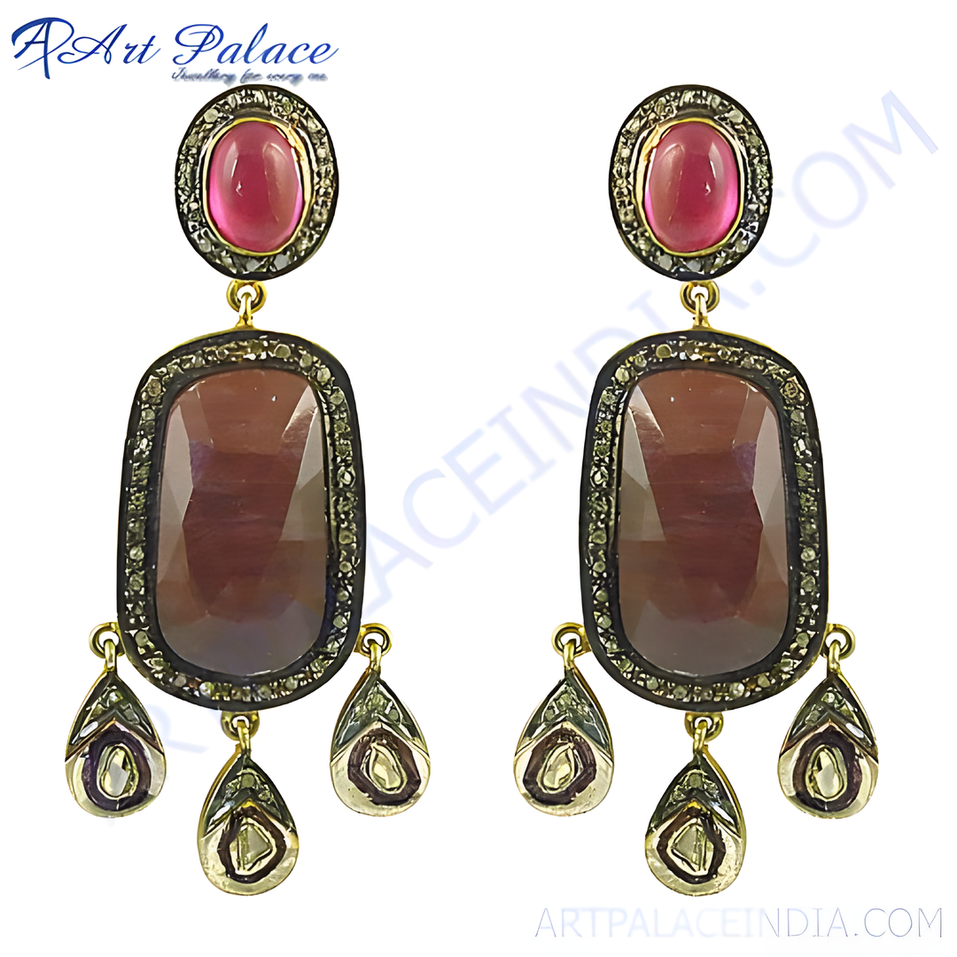 Gold finish ruby and diamond dangle earrings for women. Featuring red ruby gemstones and sparkling diamonds.
