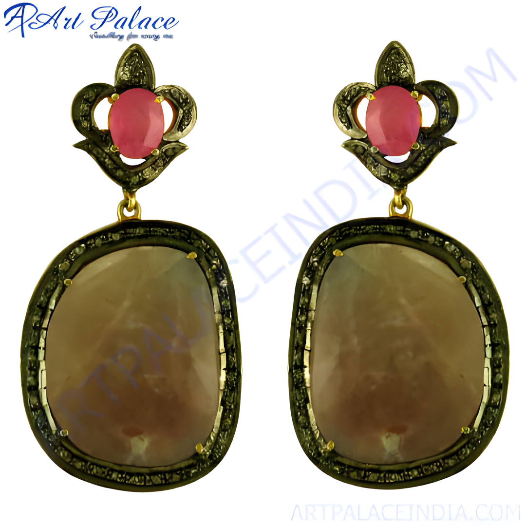 Gold finished dangle earrings with ruby gemstones and small diamonds, perfect for a special occasion.