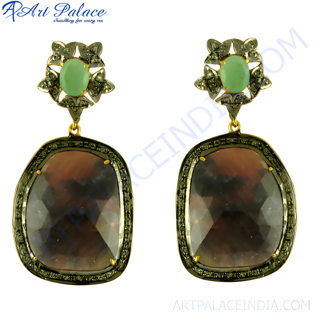 Dangle earrings featuring a large brown gemstone and a green gemstone accent, set in a detailed metal frame.
