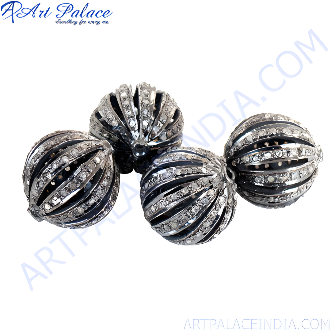 Close-up of four oxidized silver bead charms with gemstone accents on a white background.