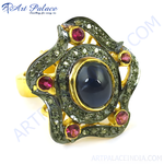 Load image into Gallery viewer, Gold plated cocktail ring with a large blue sapphire center stone and smaller ruby gemstones.
