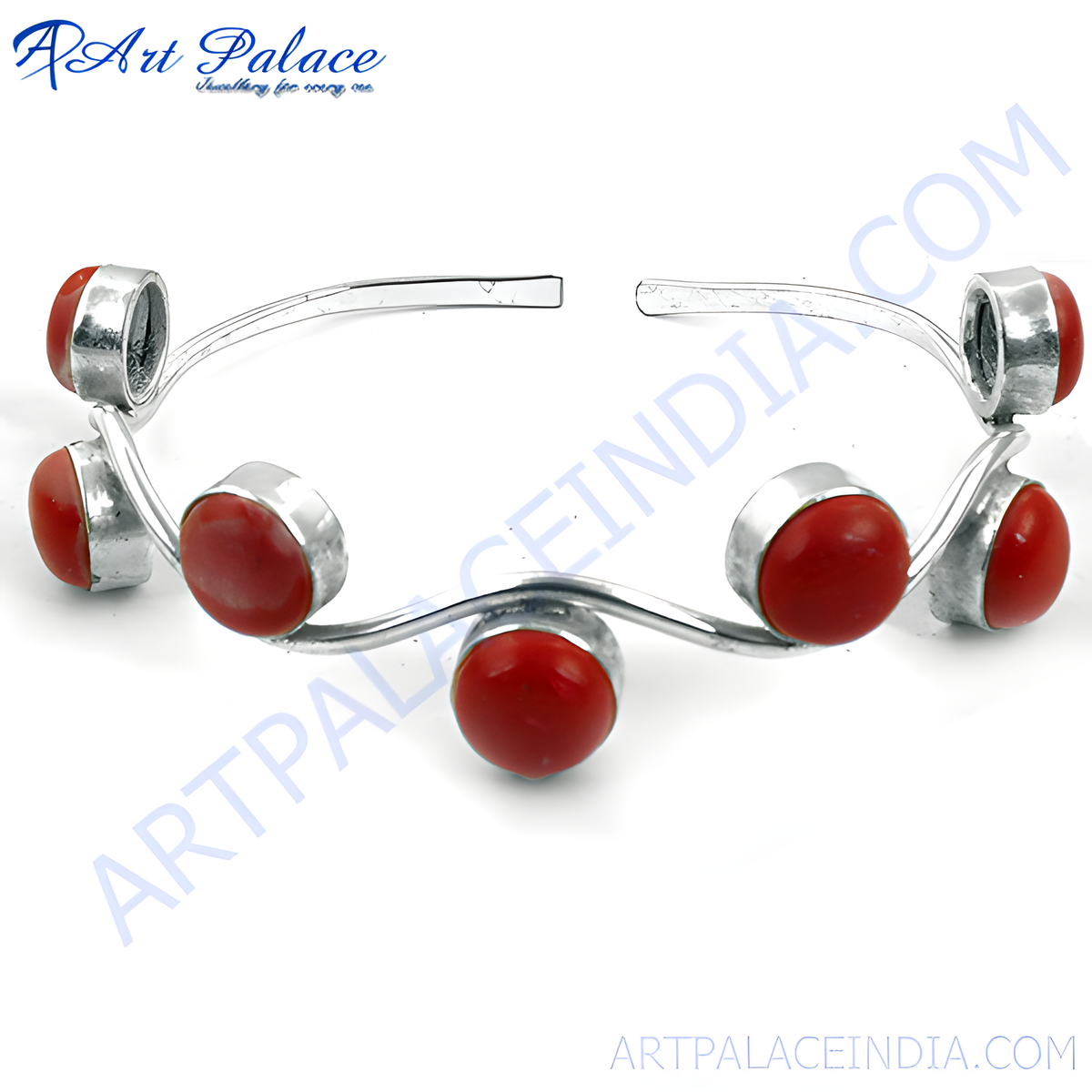 Silver bangle bracelet with red coral stones, a statement piece of jewelry